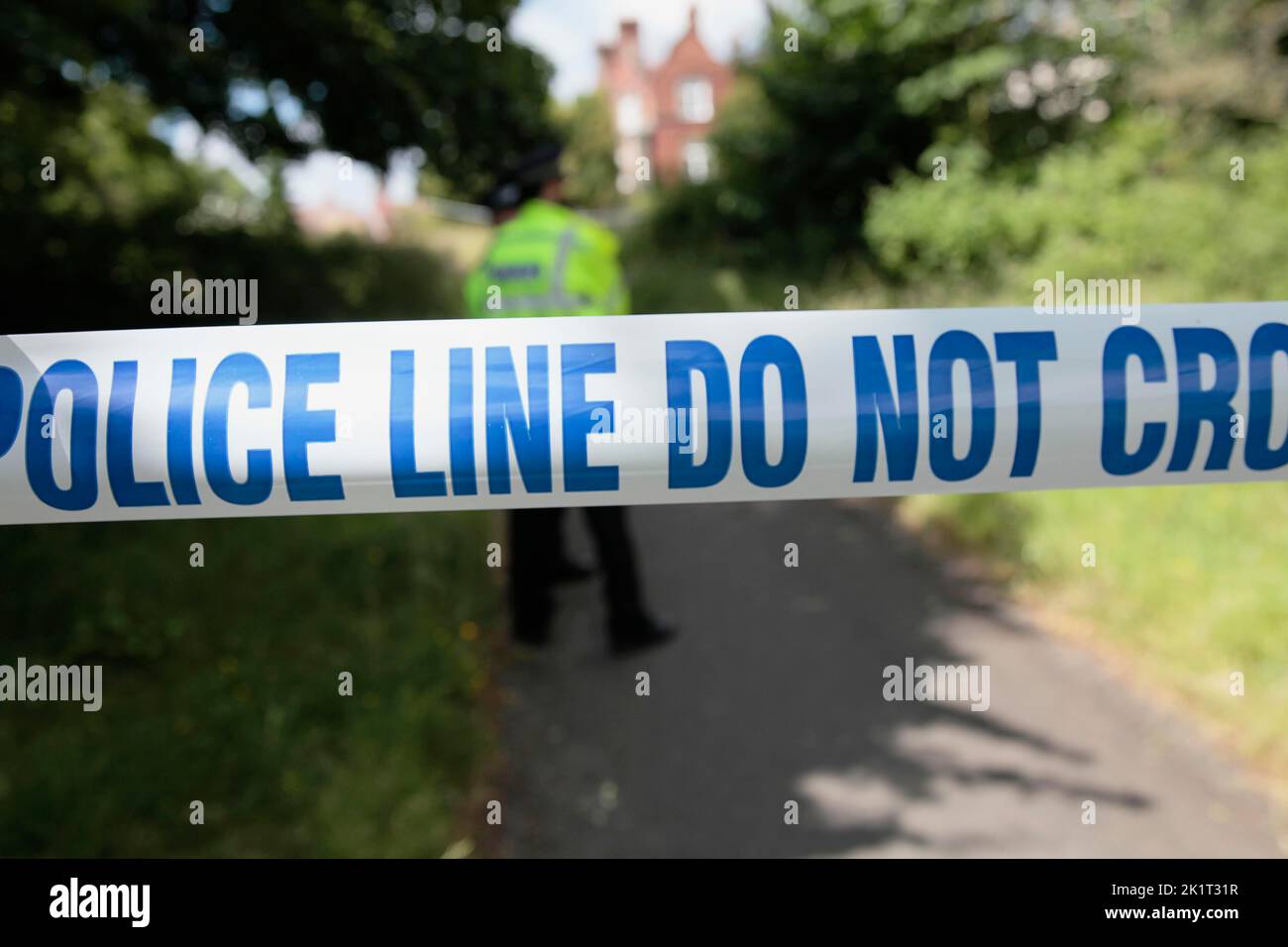 Law & Order, Police, Don Not Cross tape across footpath during investigation of a crime. Stock Photo