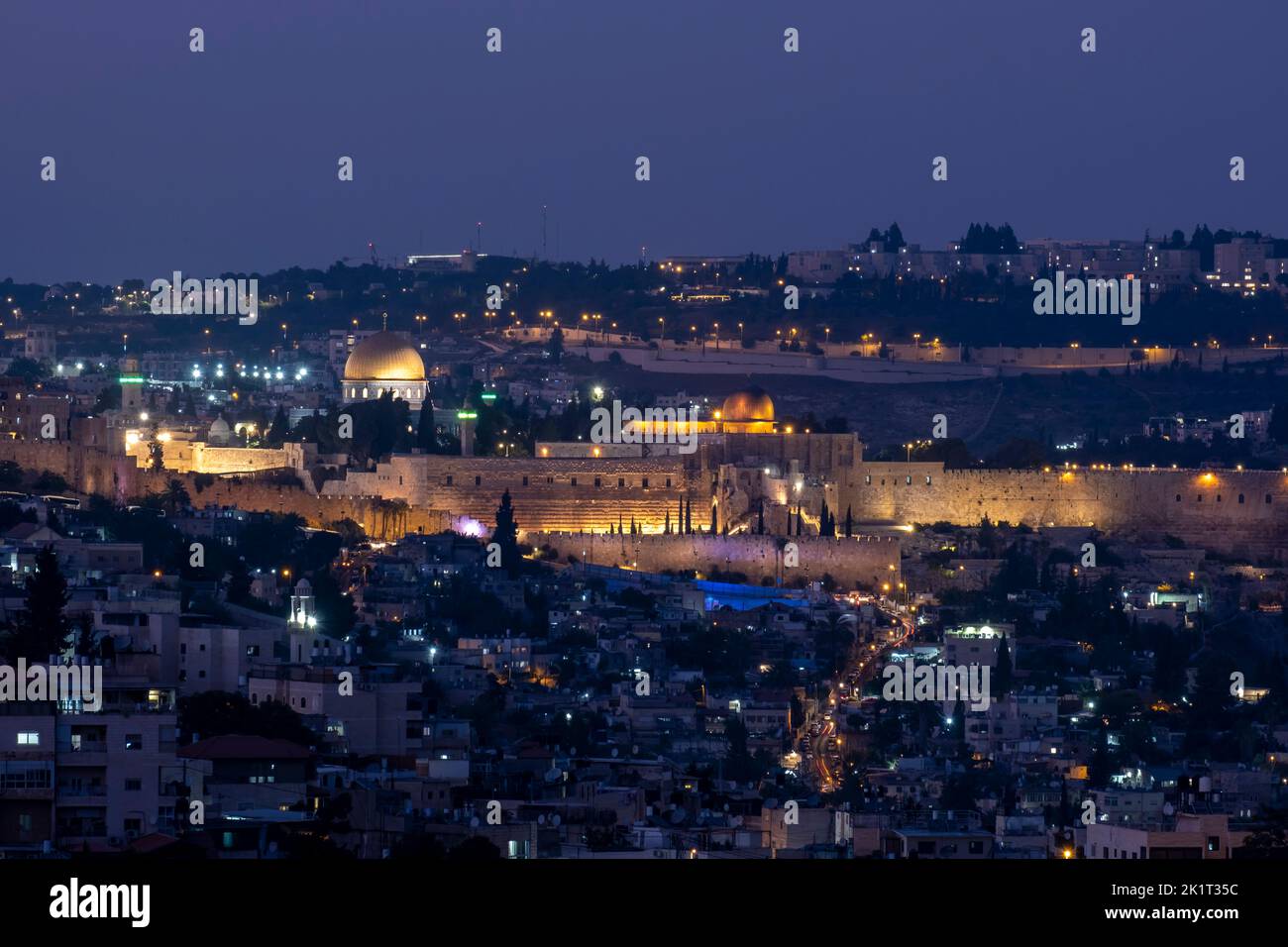 View at twilight of the Dome of the Rock and Al-Aksa Mosque built on top of the Temple Mount, known as the Al Aqsa Compound or Haram esh-Sharif across the Palestinian neighborhood of Silwan in East Jerusalem, Israel Stock Photo