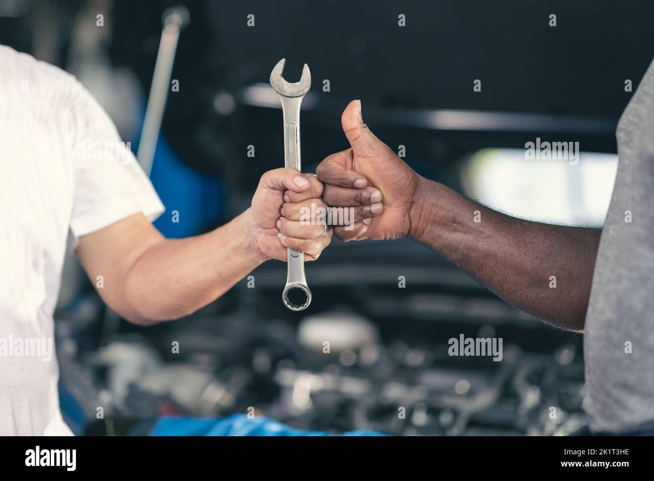 Garage worker mechanic thumb up hand with tool. Finished Work Job Done