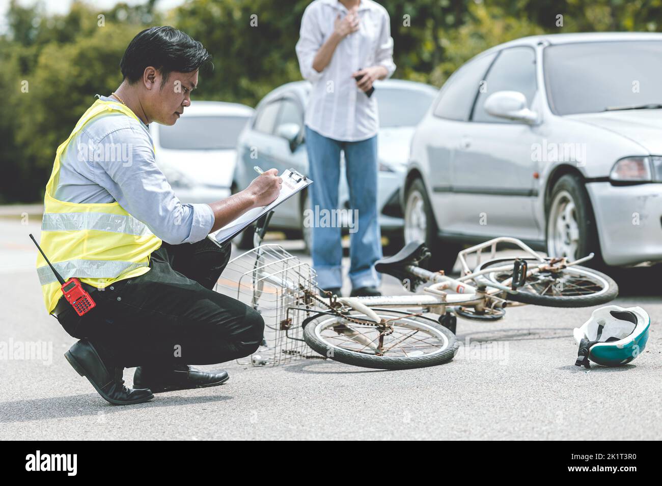 woman driver shock with car accident hit bicycle on the road claim police officer working collecting data at the scene Stock Photo