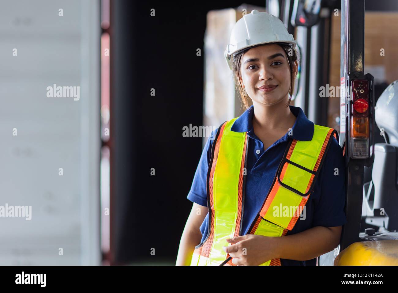 woman engineer worker Asian Latin. lady staff in safety suit work in large factory warehouse Stock Photo