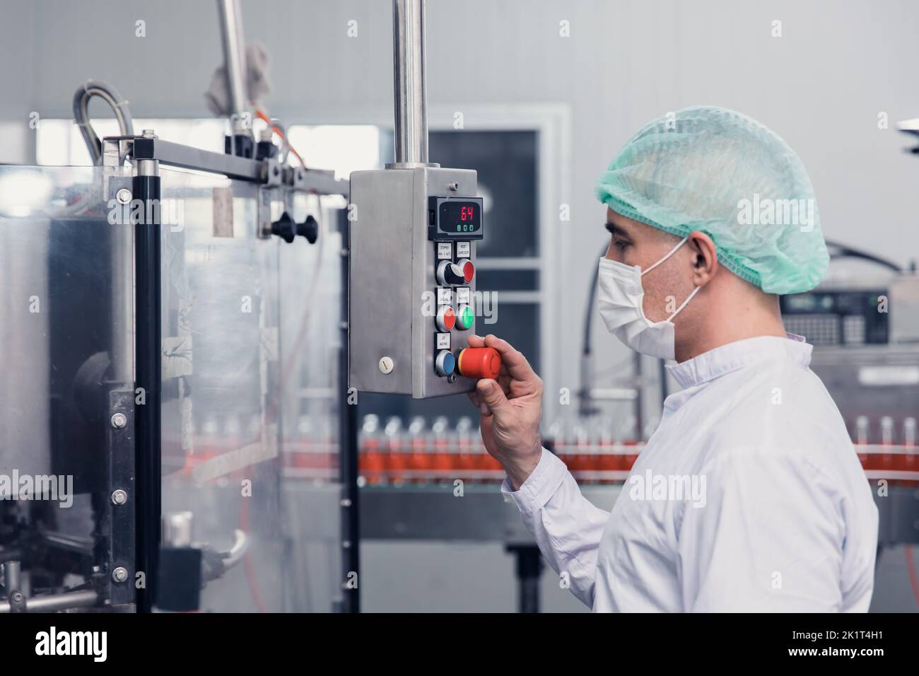 food and drink factory engineer  staff worker operate machine at production line. beverage products industry. Stock Photo