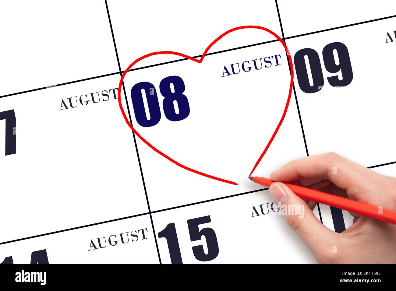 8th day of August. A woman's hand drawing a red heart shape on the calendar date of 8 August. Heart as a symbol of love. Summer month. Day of the year Stock Photo