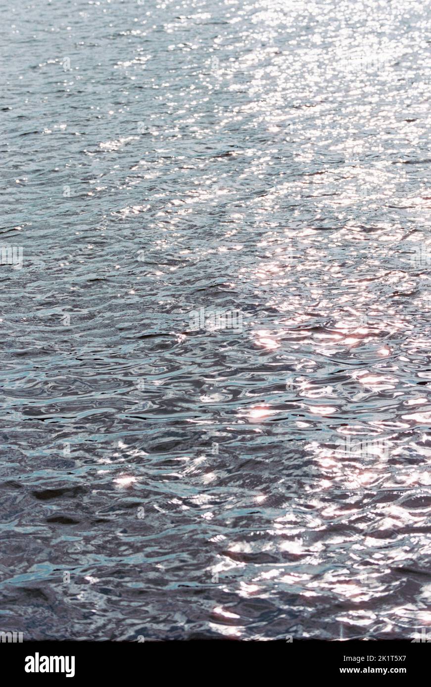 A vertical shot of a pure water surface under sunlight Stock Photo - Alamy