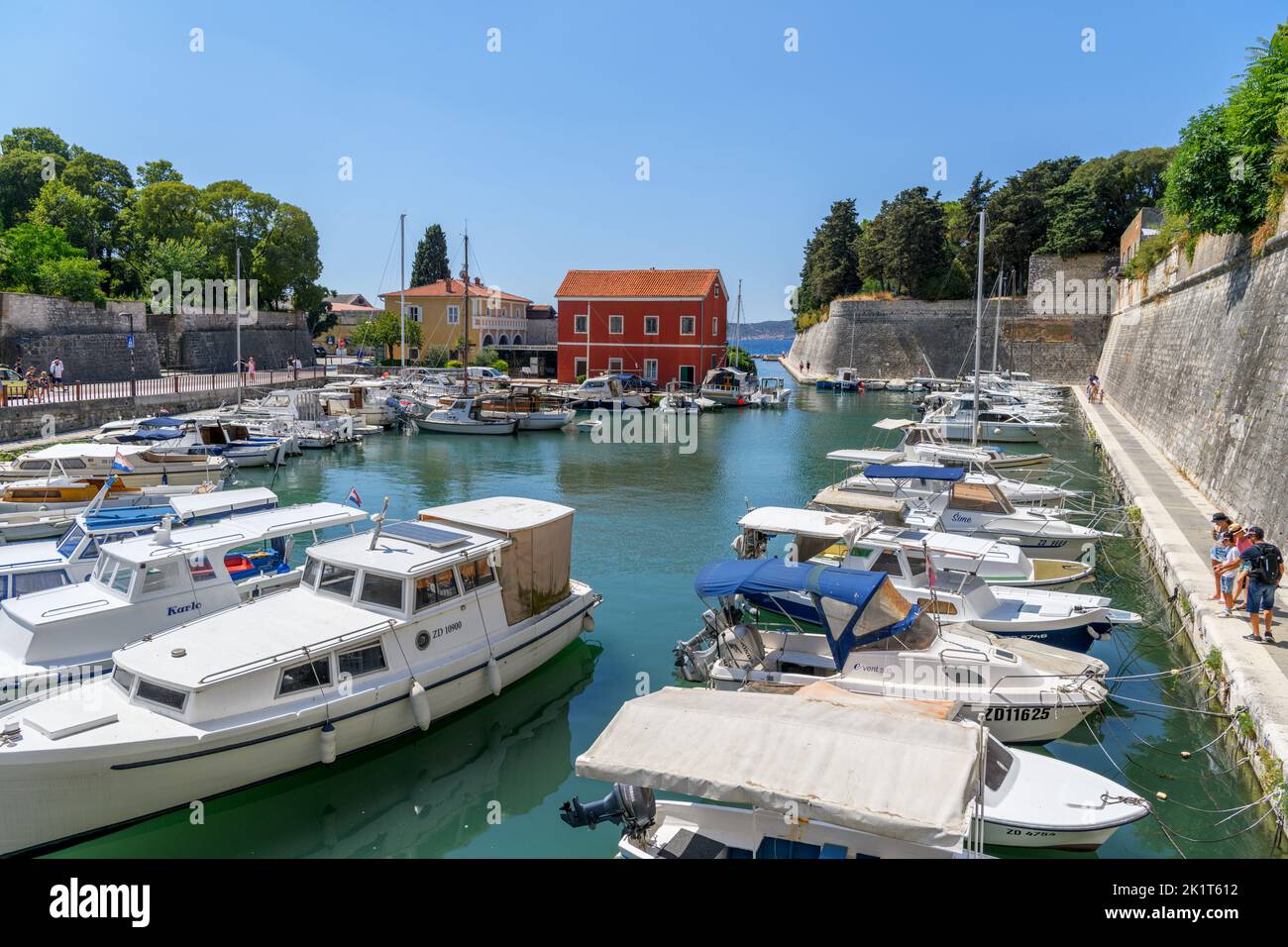 Boats moored outside the Land Gate, the historic entrance to the city of Zadar, Croatia Stock Photo
