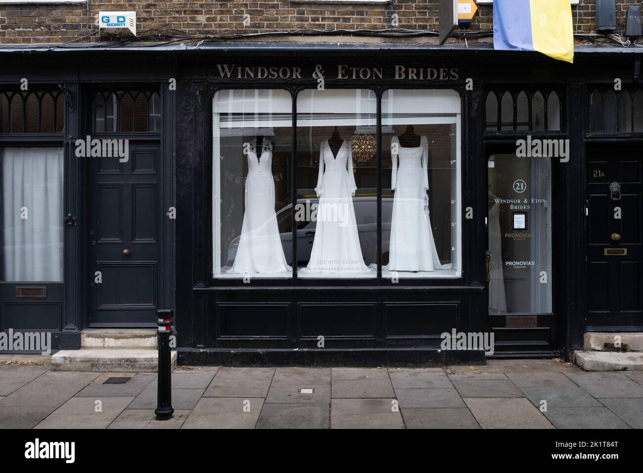 Shop window with wooden frame painted black in a Windsor shopping street selling wedding dresses. "Windsor and Eton Brides" Stock Photo