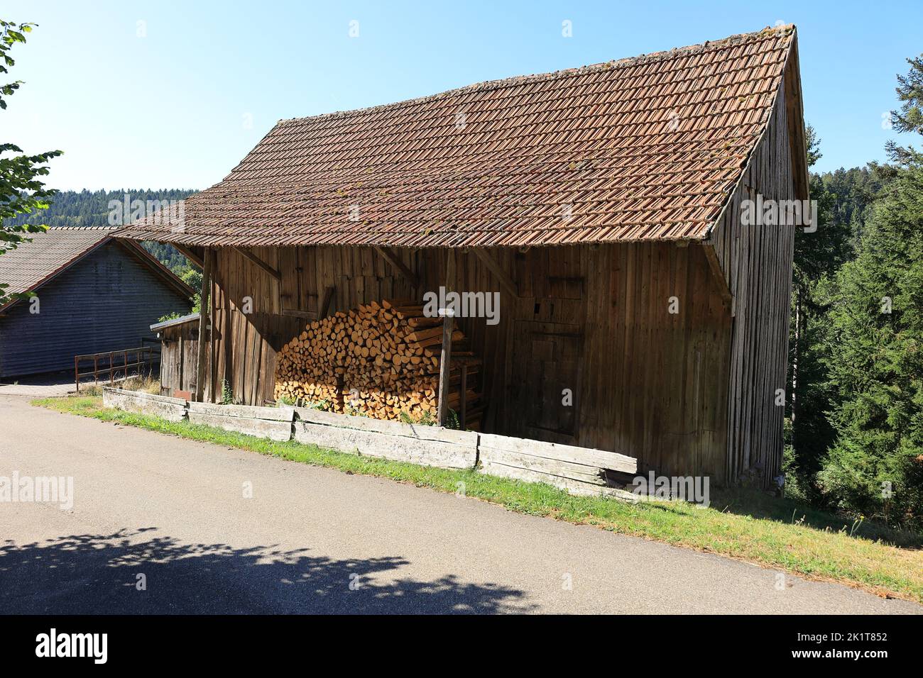 Wooden hut in Berneck near Altensteig with firewood in front Stock Photo