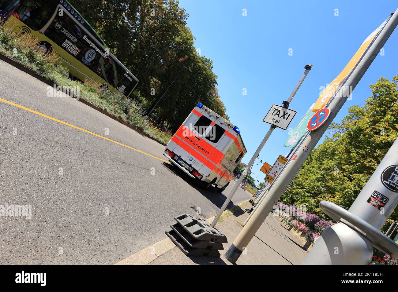 Ambulance with flashing lights and the inscription Intensive Transport on the way in Ludwigsburg and photographed at an angle Stock Photo