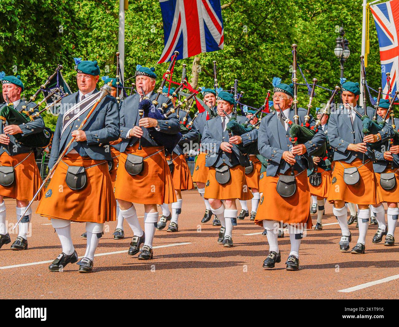 London United Kingdom June 15 2009; Typical British pomp and ceremony on The Mall marchers and bagpipes under draped Union Jack Flags.. Stock Photo