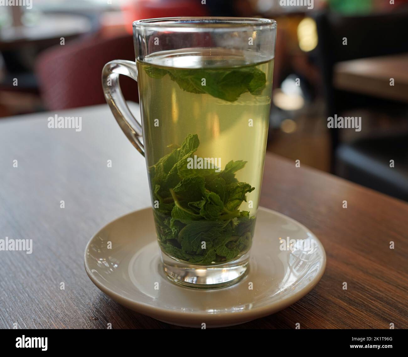 transparent glass with hot fresh mint tea in a restaurant in Detmold, Germany Stock Photo