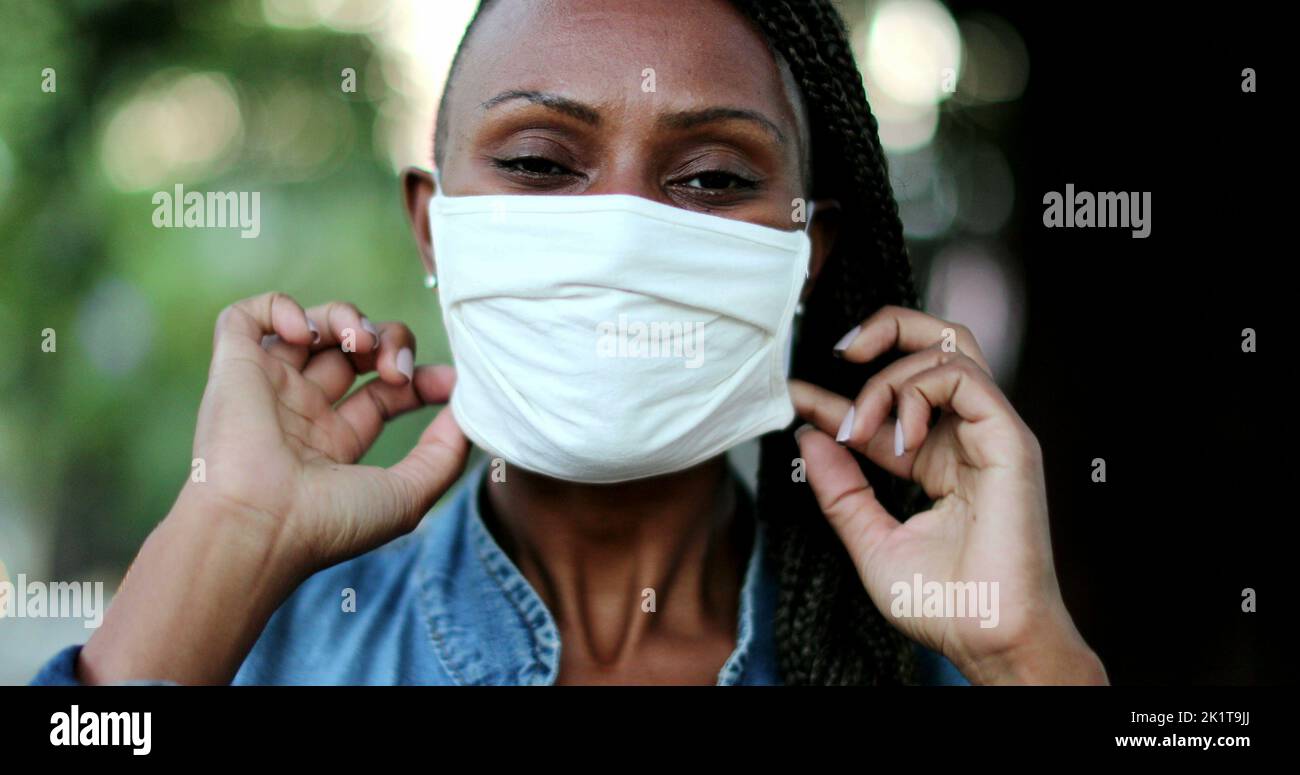 African woman putting face mask hi-res stock photography and images - Alamy