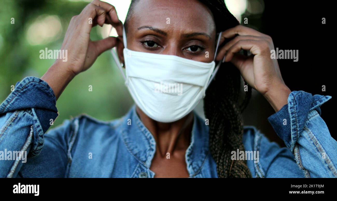 African woman putting face mask hi-res stock photography and images - Alamy