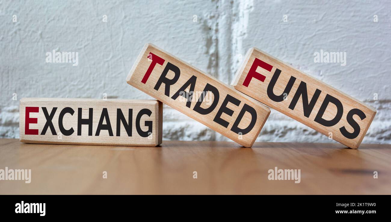 On a beautiful background, wooden blocks with the text ETF Exchange Traded Funds. Manufacture of wooden toys. Stock Photo