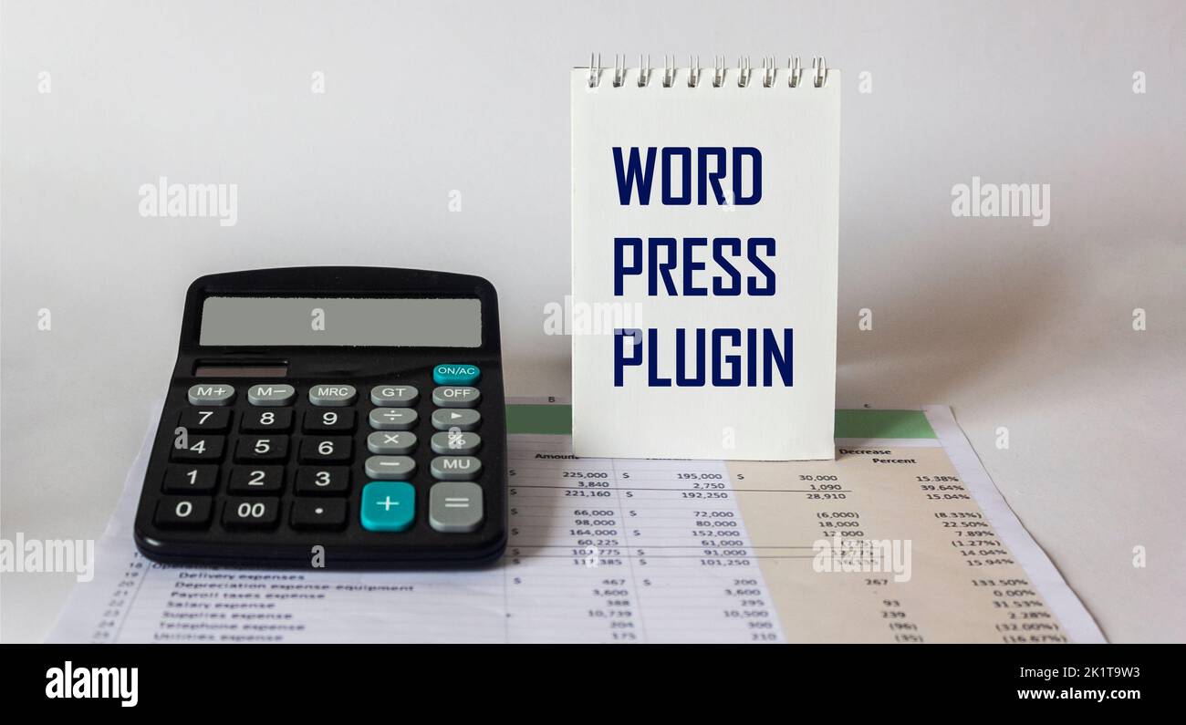 On a light background, a calculator with documents and a notepad with the text WORD PRESS PLUGIN Stock Photo