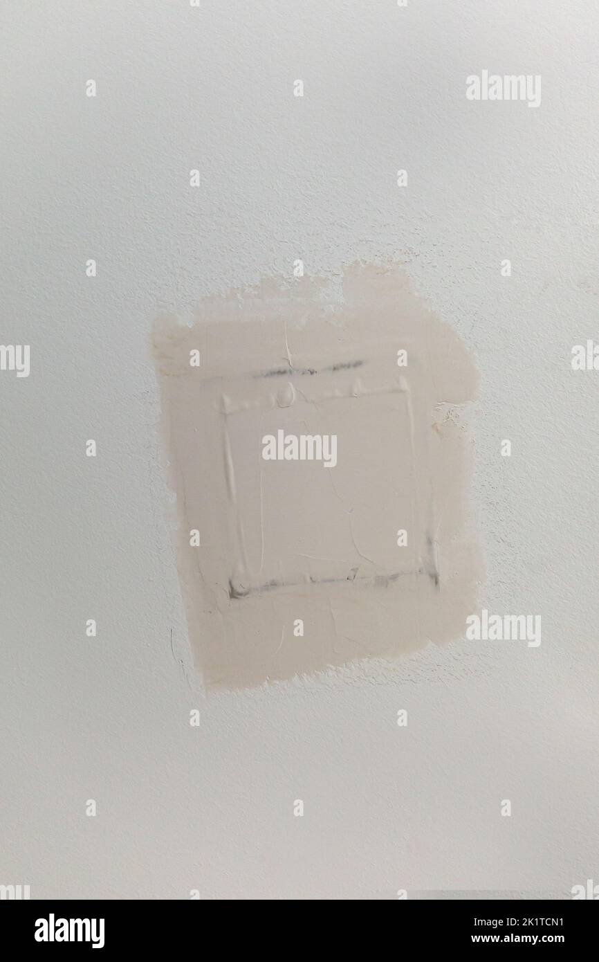 A patch in gray brown greige textured white ceiling of a new construction house. Stock Photo