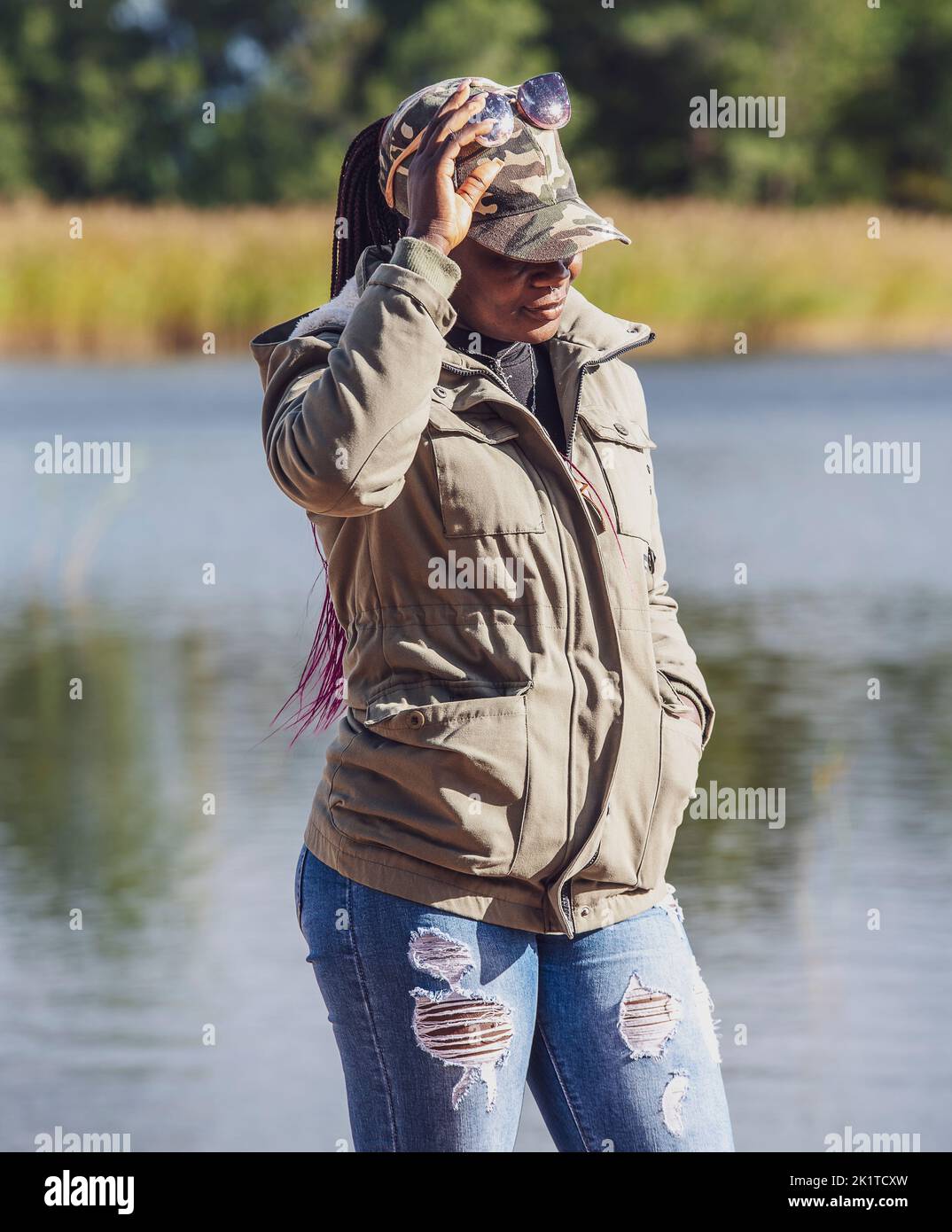 African woman wearing autumn clothes on a sunny September day on the Swedish coast Stock Photo