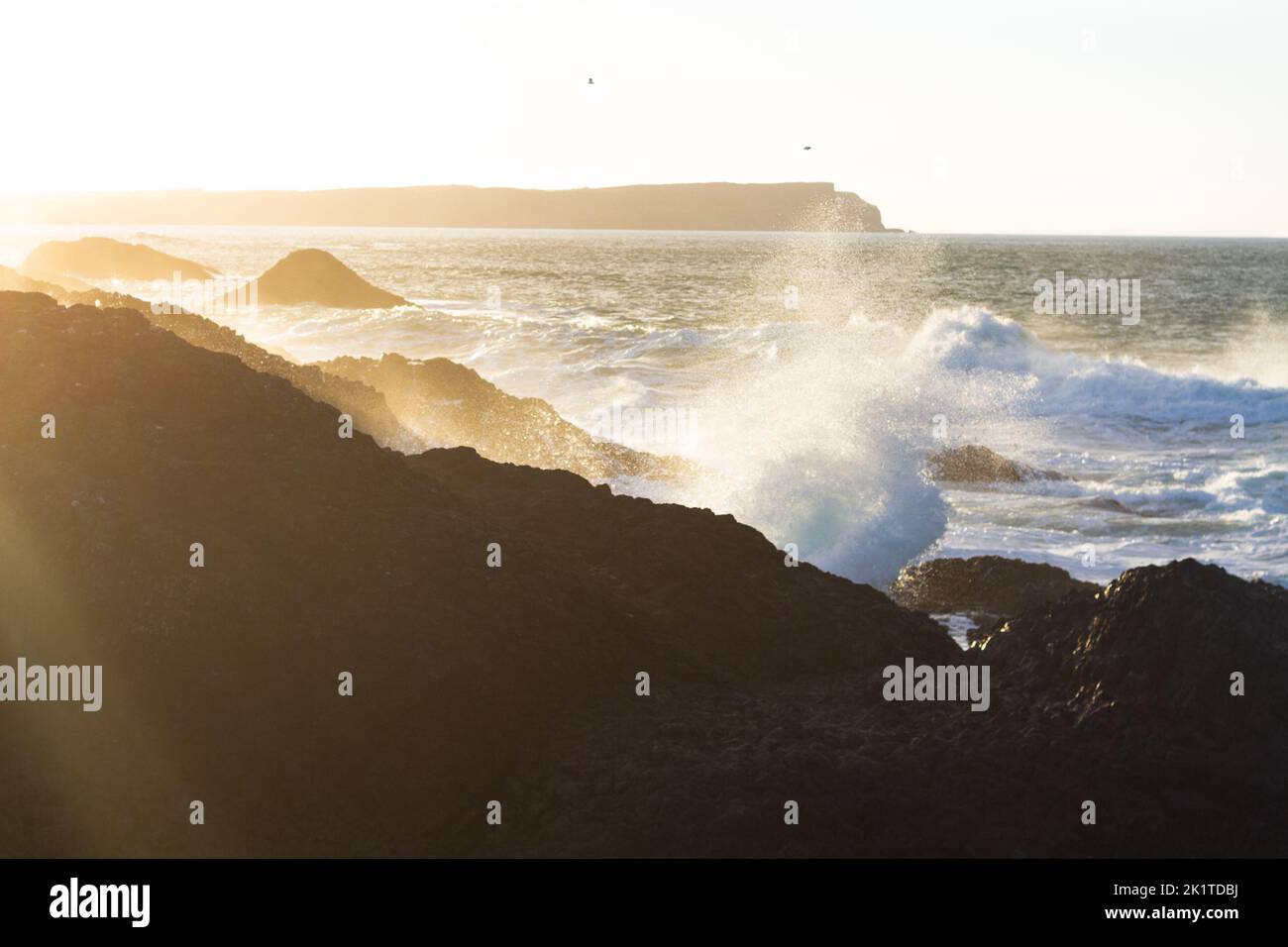 A view of the waves hitting the rocky cliffs Stock Photo - Alamy