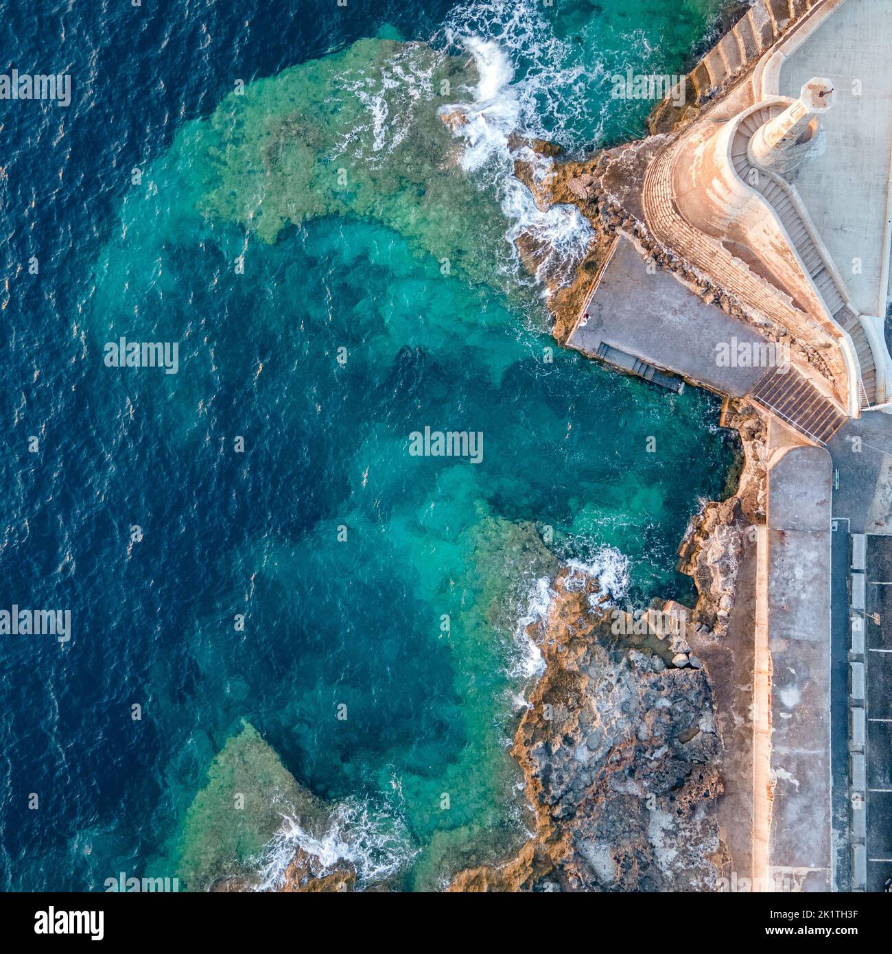 Cirkewwa dive site, rocky coastline and hues of blue on a sunset, Malta Stock Photo