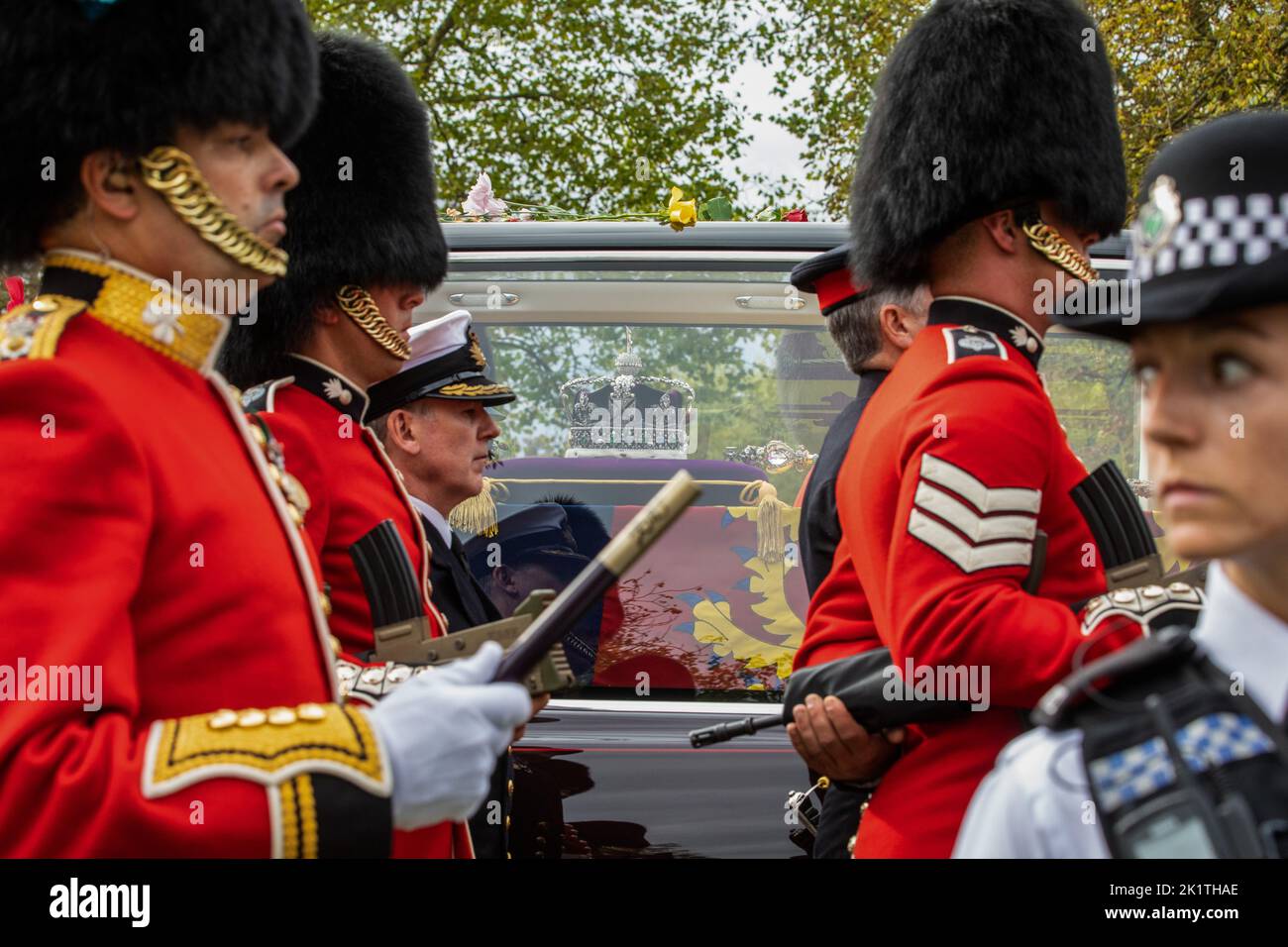 Windsor, UK. 19th September, 2022. Grenadier Guards and other military personnel escort Queen Elizabeth II's coffin lying with the Imperial State Crown in the State Hearse on the Long Walk in Windsor Great Park during a procession from Shaw Farm Gate to St George’s Chapel for the Committal Service. Queen Elizabeth II, the UK's longest-serving monarch, died at Balmoral aged 96 on 8th September 2022 after a reign lasting 70 years. Credit: Mark Kerrison/Alamy Live News Stock Photo