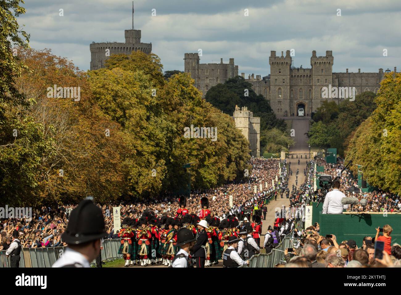 Windsor, UK. 19th September, 2022. Mourners watch the Massed Pipes and Drums of Scottish and Irish Regiments proceed along the Long Walk in Windsor Great Park prior to the procession of Queen Elizabeth II's coffin in the State Hearse to St George’s Chapel for the Committal Service. Queen Elizabeth II, the UK's longest-serving monarch, died at Balmoral aged 96 on 8th September 2022 after a reign lasting 70 years. Credit: Mark Kerrison/Alamy Live News Stock Photo