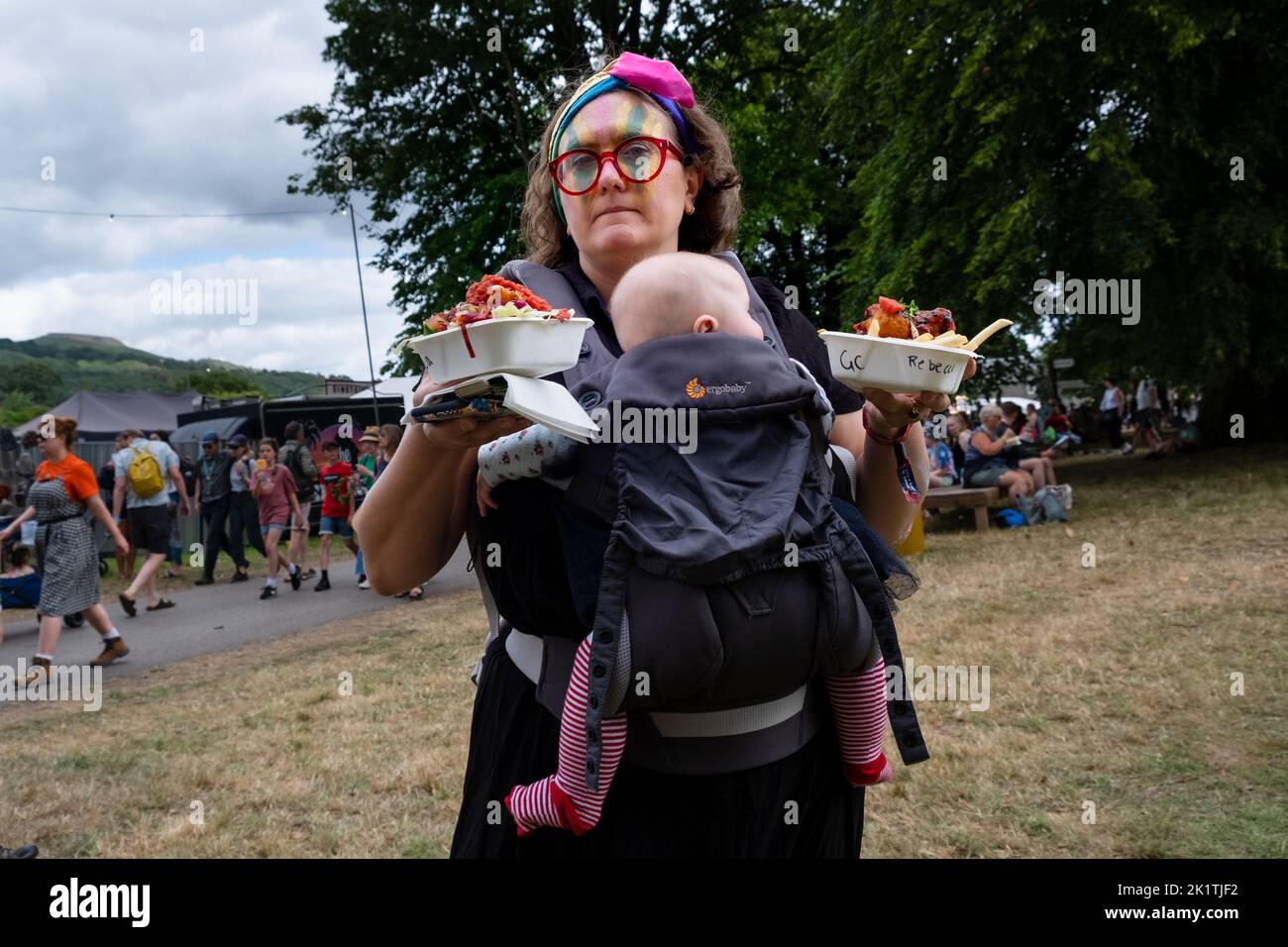 Fast food and a baby in the festival crowd at the Green Man 2022 music festival in in Wales, UK, August 2022. Photograph: Rob Watkins/Alamy Stock Photo
