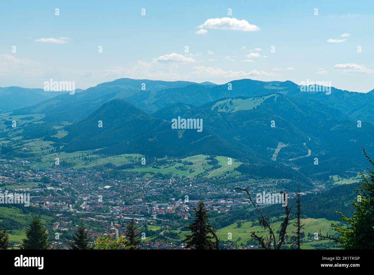 Ruzomberok town with hills of Velka Fatra mountains above in Slovakia - view from Predny Choc hill in Chocske vrchy mountains Stock Photo
