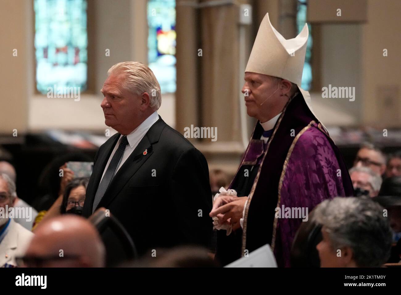 Bishop of Toronto the Right Reverend Andrew Asbil escorts to Ontario  Premier Doug Ford to his seat at a provincial commemorative service for  Queen Elizabeth at St. James Cathedral in Toronto on