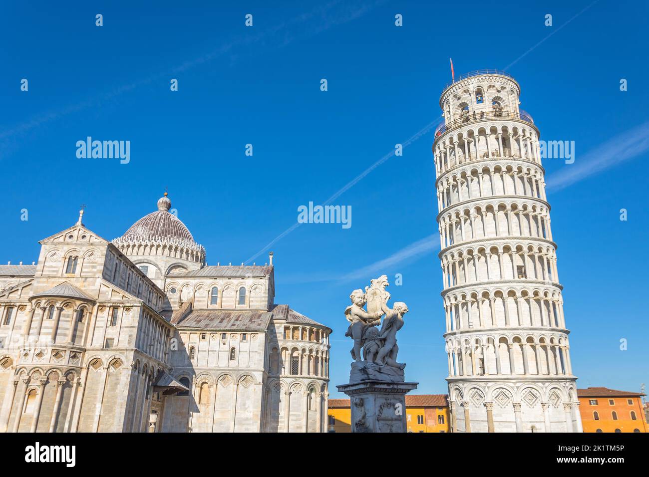 Pisa cathedral and the leaning tower and sculpture in a sunny day in Pisa, Italy Stock Photo