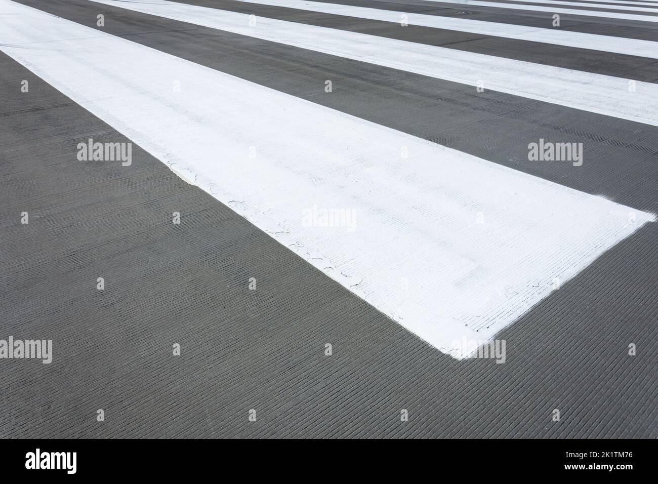 White stripes on grey asphalt, concrete marking Stock Photo