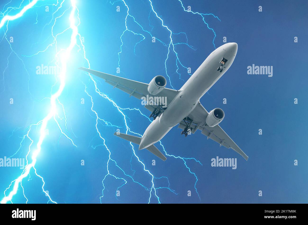 Powerful lightning strike in a thunderstorm near the plane. Stock Photo