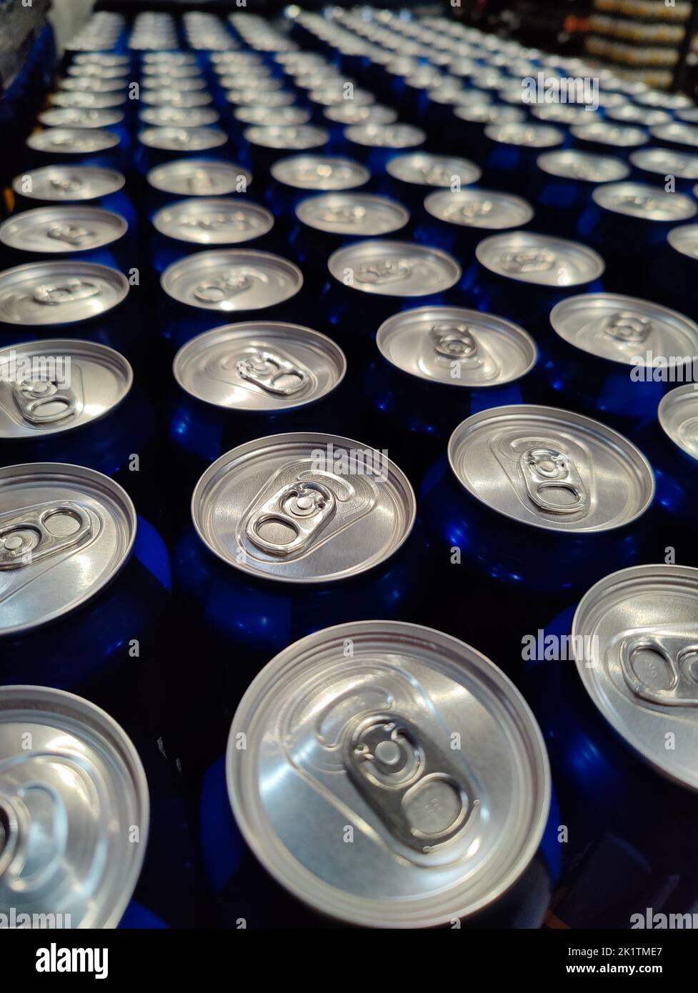 A blue soda can lined at the factory Stock Photo Alamy