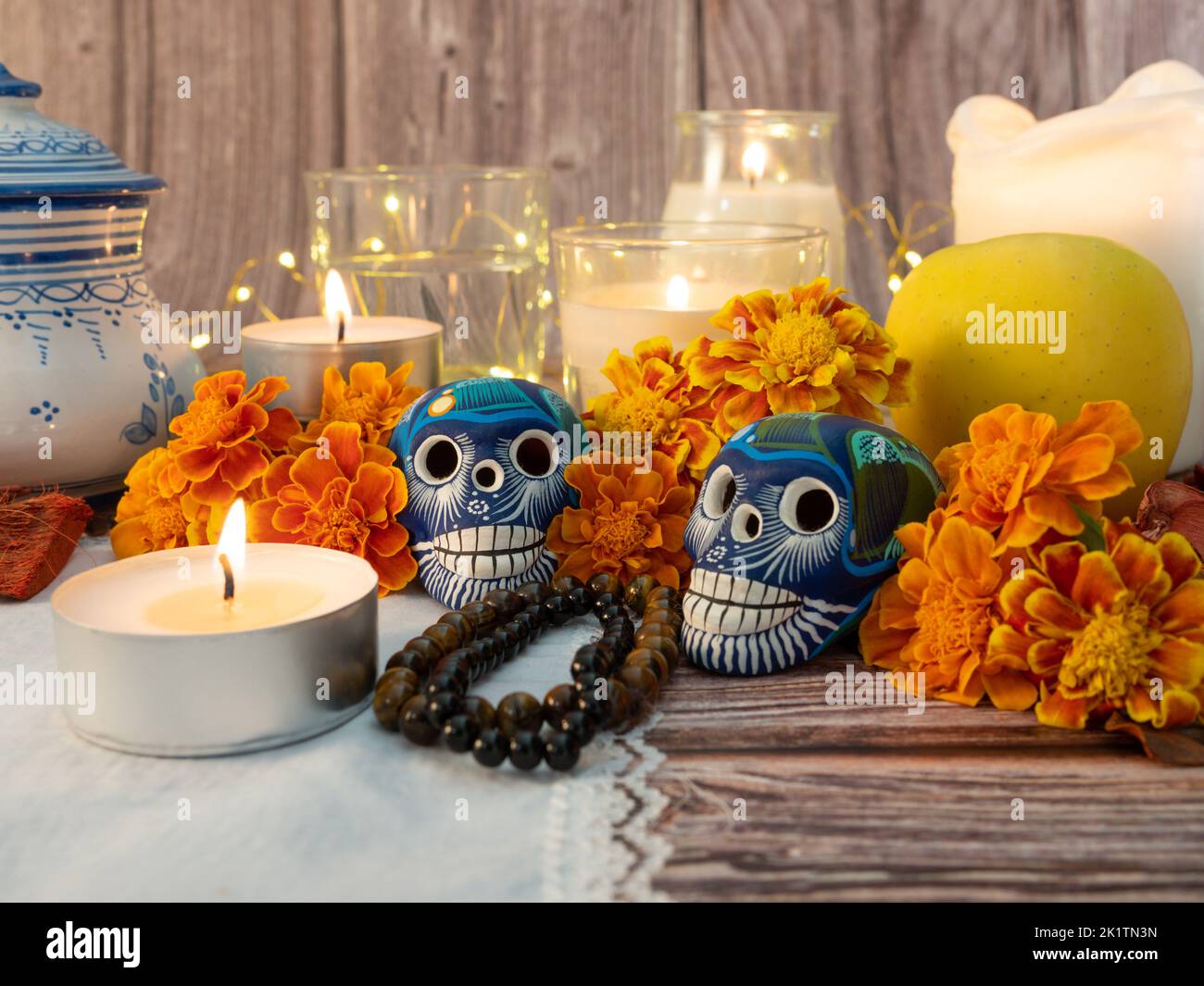 Spanish Mexican traditional autumn festival day of the dead typical Mexican skull with flowers painted on wood background , decorations and marigold f Stock Photo