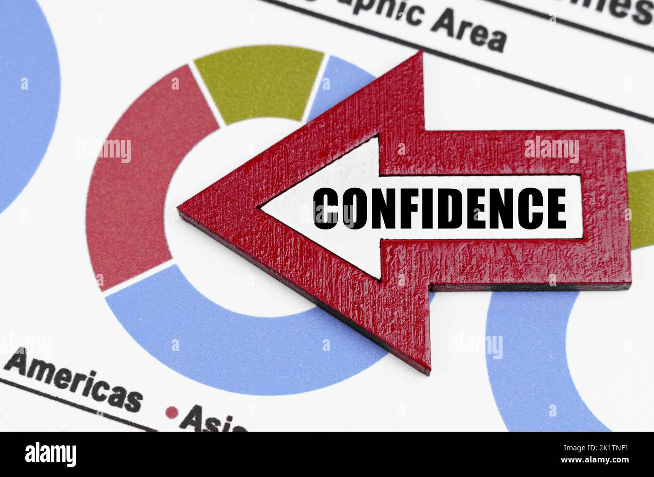 Business concept. Against the background of the diagrams, an arrow with the inscription - Confidence Stock Photo