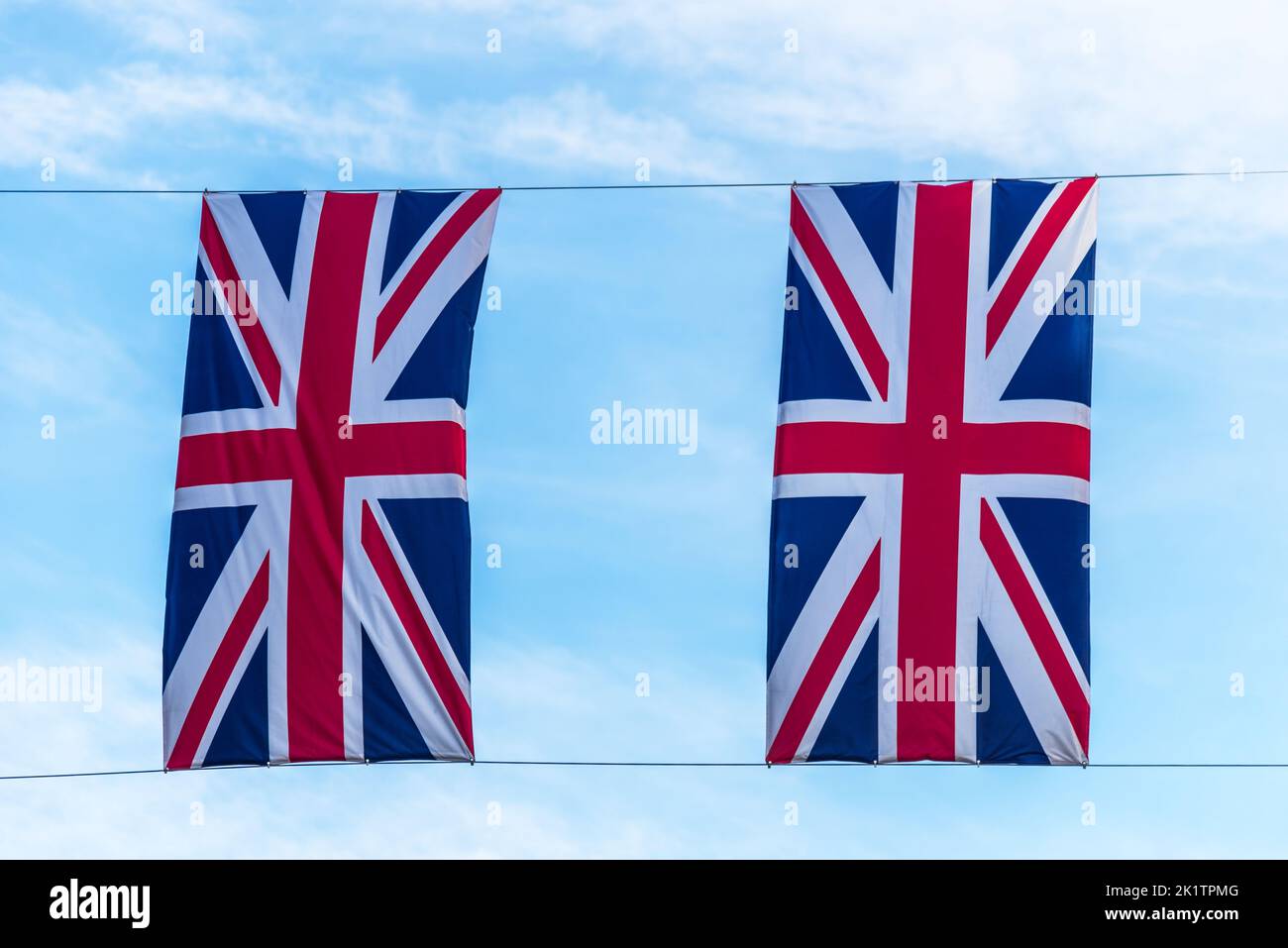 Two United Kingdom flag highlighted in the blue sky Stock Photo - Alamy