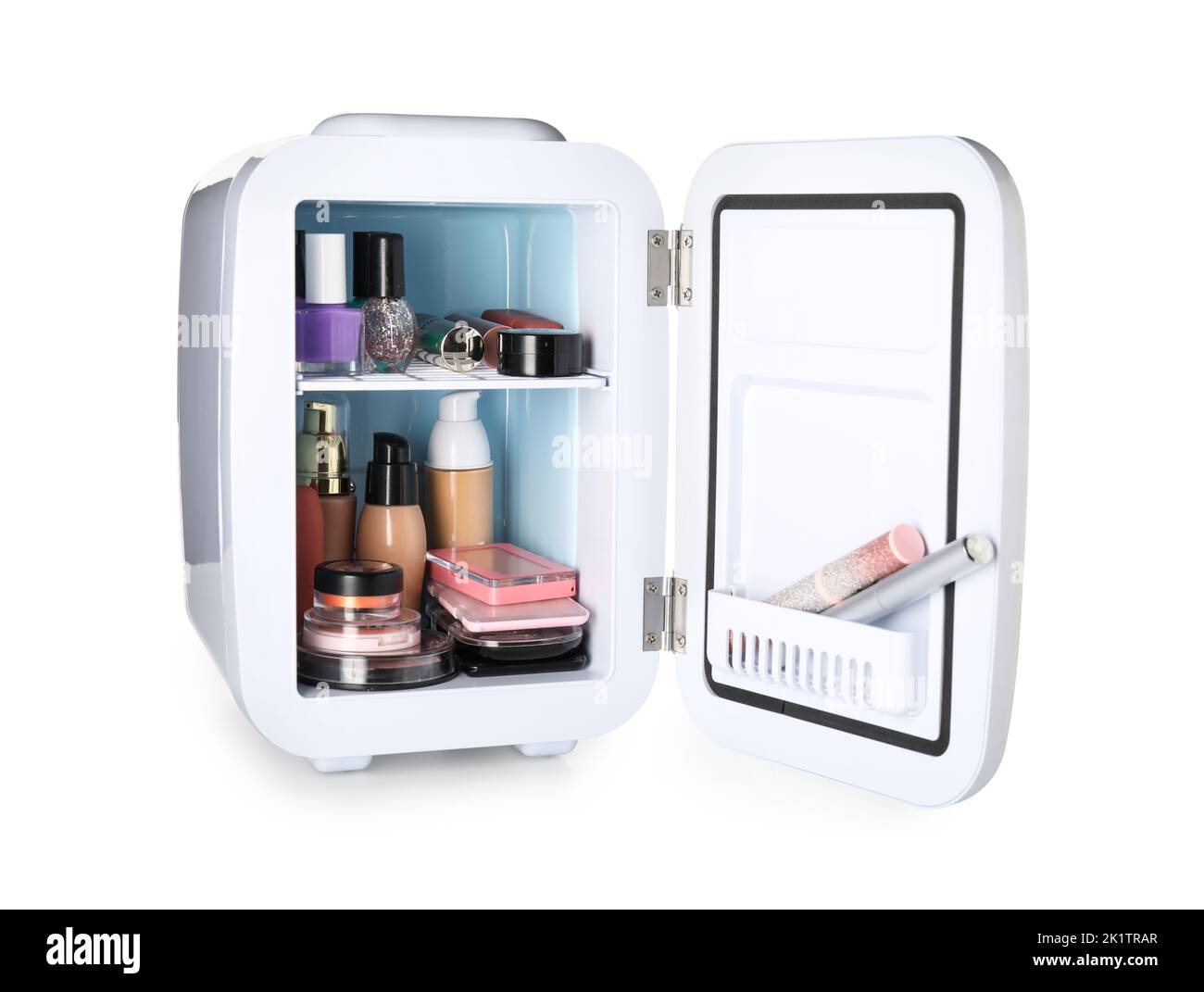 Small refrigerator with makeup products on white background Stock Photo