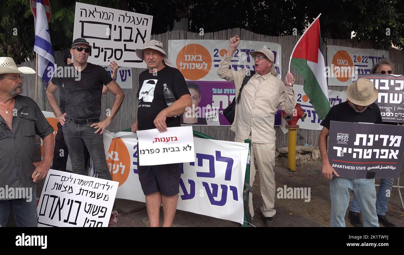 An Israeli peace activist holds the Palestinian flag as he takes part with others in a protest in front of Bleich school, against the visit of extreme Right-wing lawmaker Itamar Ben-Gvir, in the school on September 20, 2022 in Ramat Gan, Israel. Bleich High School holds a mock parliamentary election and panel ahead of every election, inviting members of all parties to participate. The high school has earned a reputation for accurately predicting the results of previous Knesset elections. Stock Photo