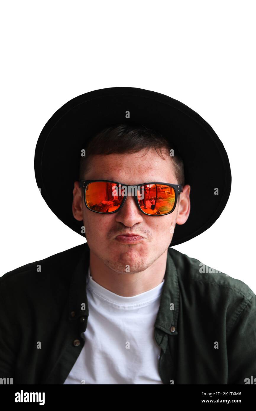 Funny man isolated. Smiling fashion man. Portrait of handsome smiling stylish hipster lambersexual model. Man dressed in red sunglasses and hat. Fashi Stock Photo