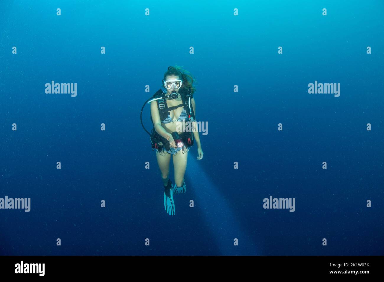 A female diver (MR) in mid water, open ocean, off the island of Yap, Micronesia. Stock Photo