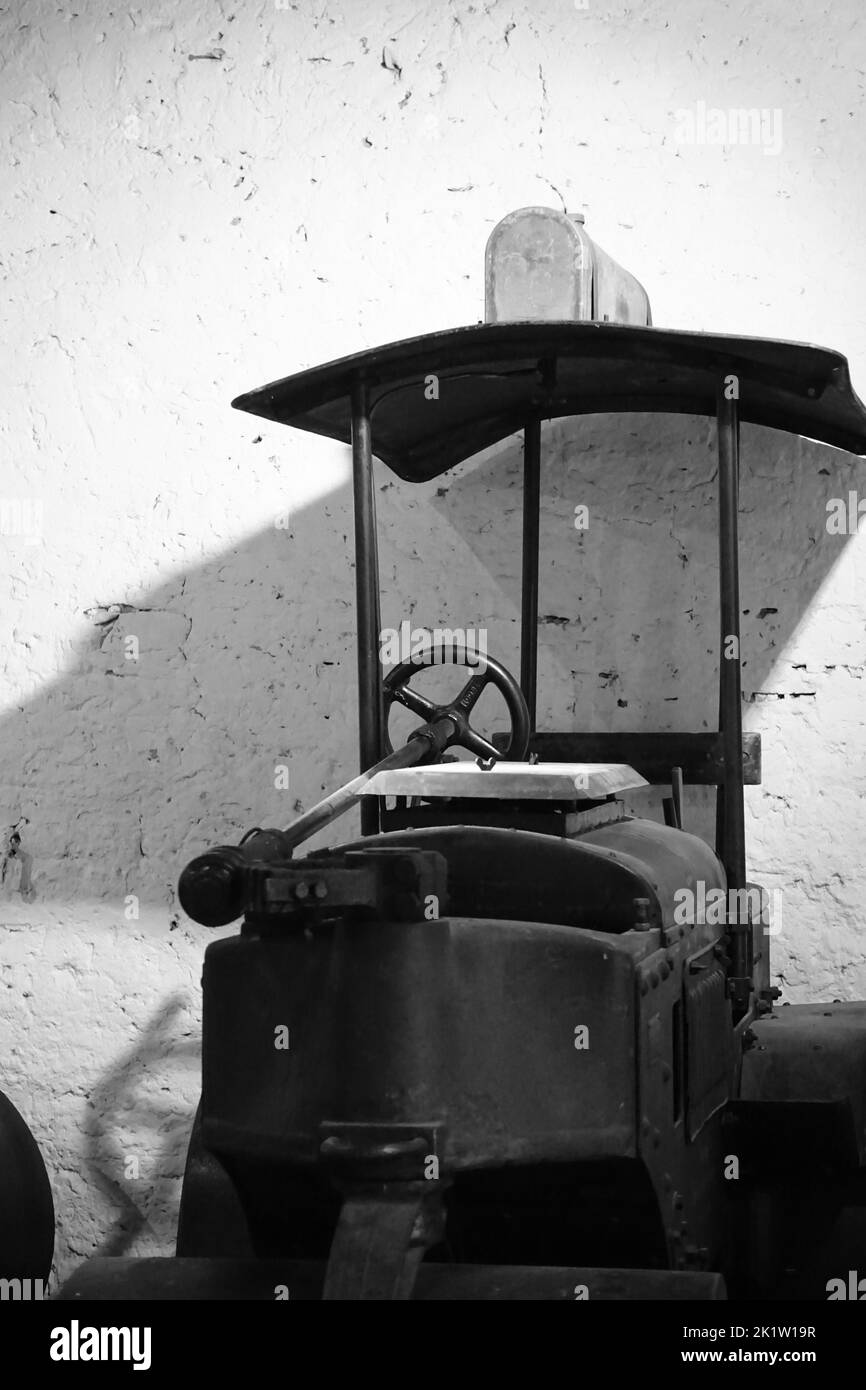 A vertical black and white shot of an old road roller Stock Photo