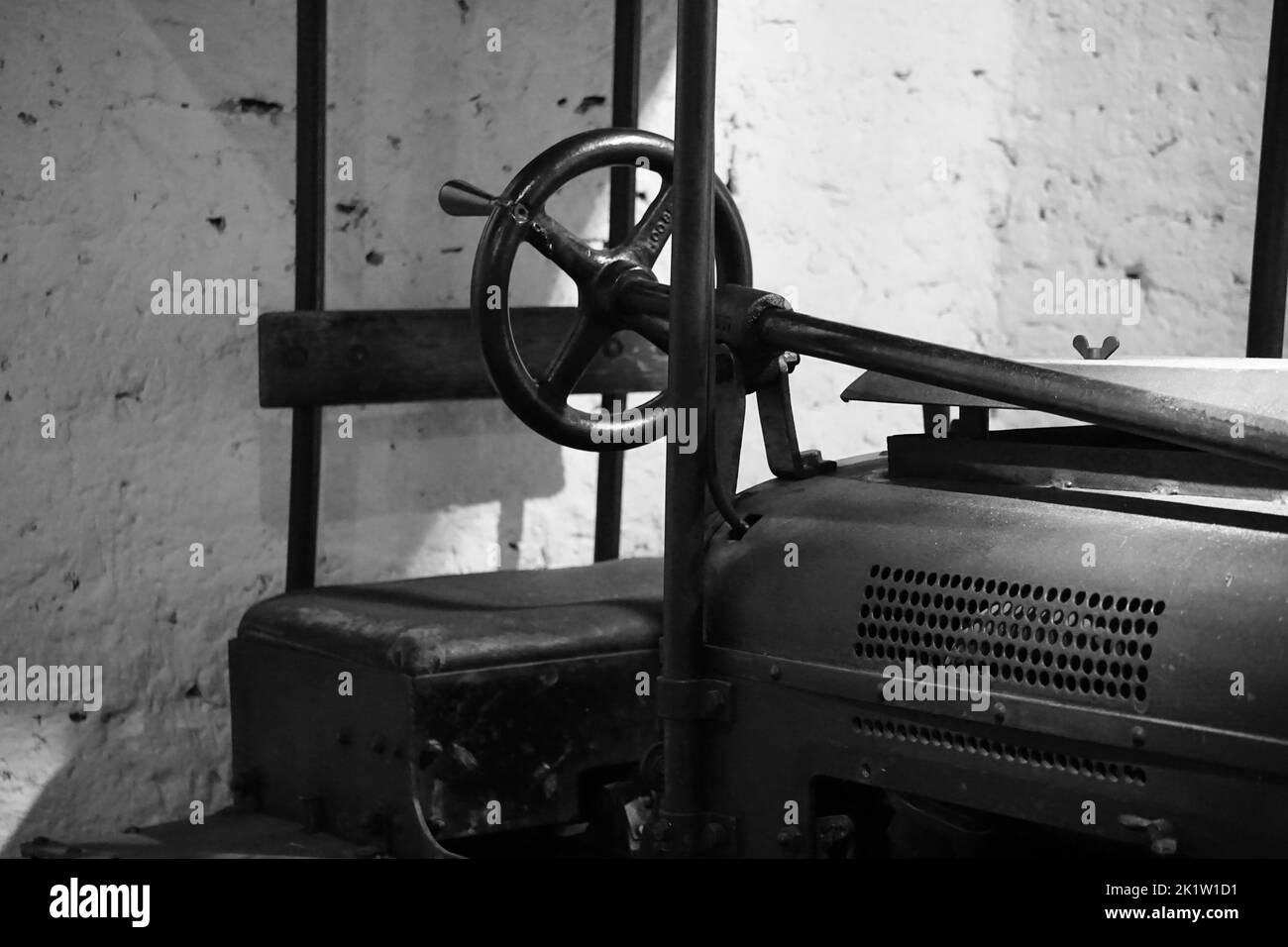 A black and white shot of the steering wheel of a road roller Stock Photo