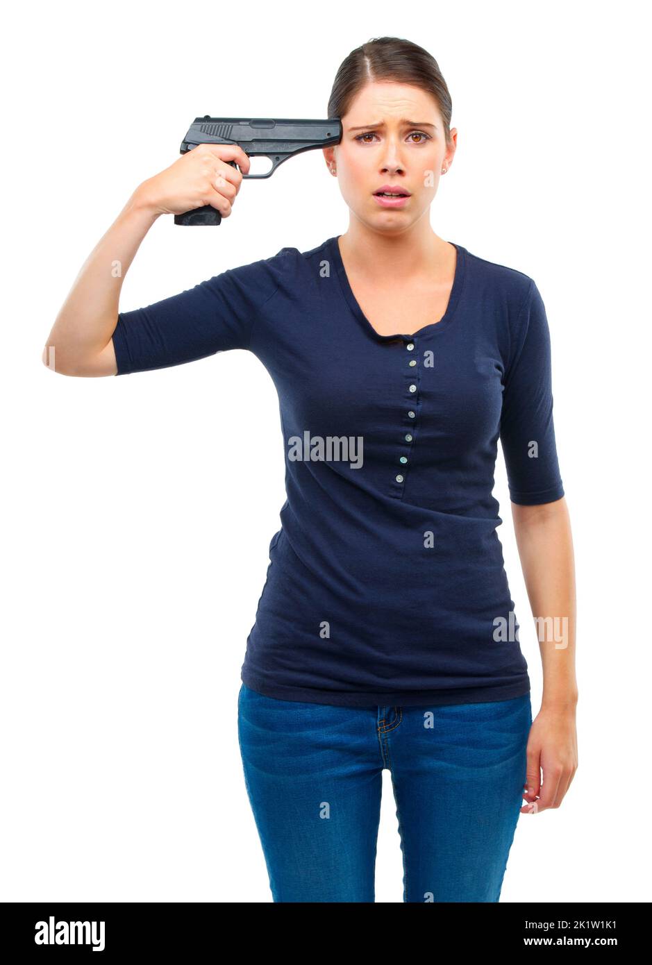 Dont become a victim of your own mind. Studio shot of a young woman pointing a gun at her head isolated on white. Stock Photo