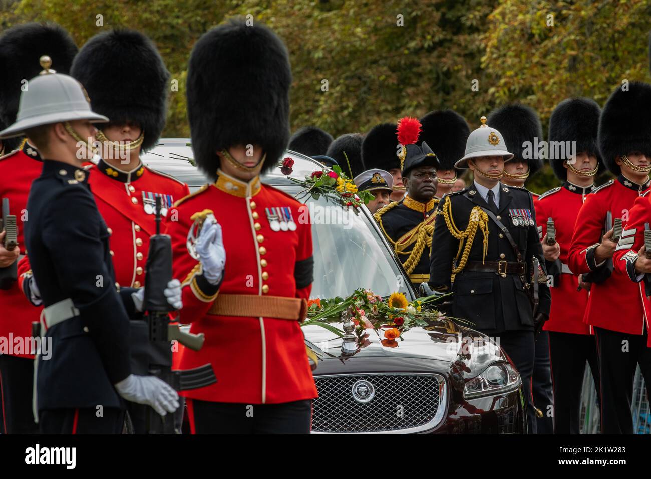 Windsor, UK. 19th September, 2022. Grenadier Guards escort Queen Elizabeth II's coffin lying in the State Hearse on the Long Walk in Windsor Great Park during a procession from Shaw Farm Gate to St George’s Chapel for the Committal Service. Queen Elizabeth II, the UK's longest-serving monarch, died at Balmoral aged 96 on 8th September 2022 after a reign lasting 70 years. Credit: Mark Kerrison/Alamy Live News Stock Photo