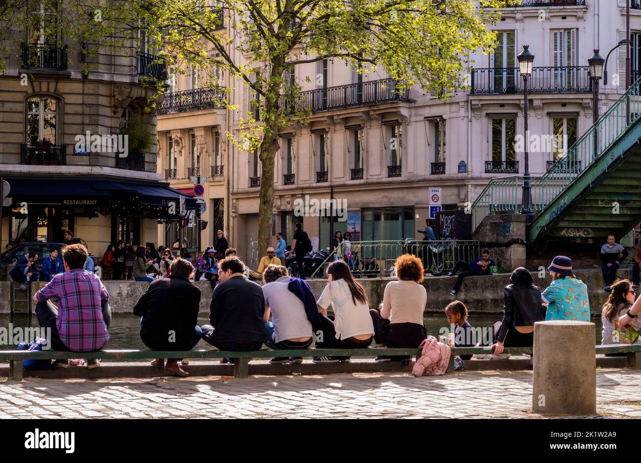 Parisians enjoy Spring in Paris along Canal Saint-Martin in the 10th Arrondissement Stock Photo
