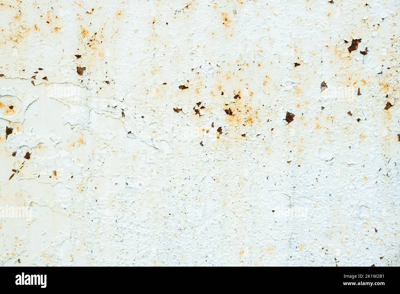 Corrosion of metal. Rust shows through the white paint. Rusty texture. Stock Photo