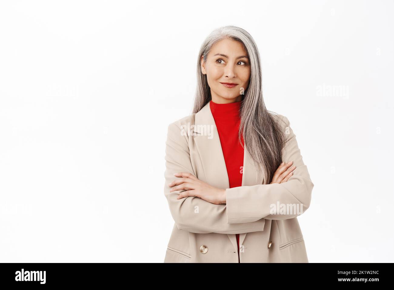 Portrait of professional asian senior businesswoman, cross arms on chest, looking confident, wearing stylish suit, smiling assertive, working in corpo Stock Photo