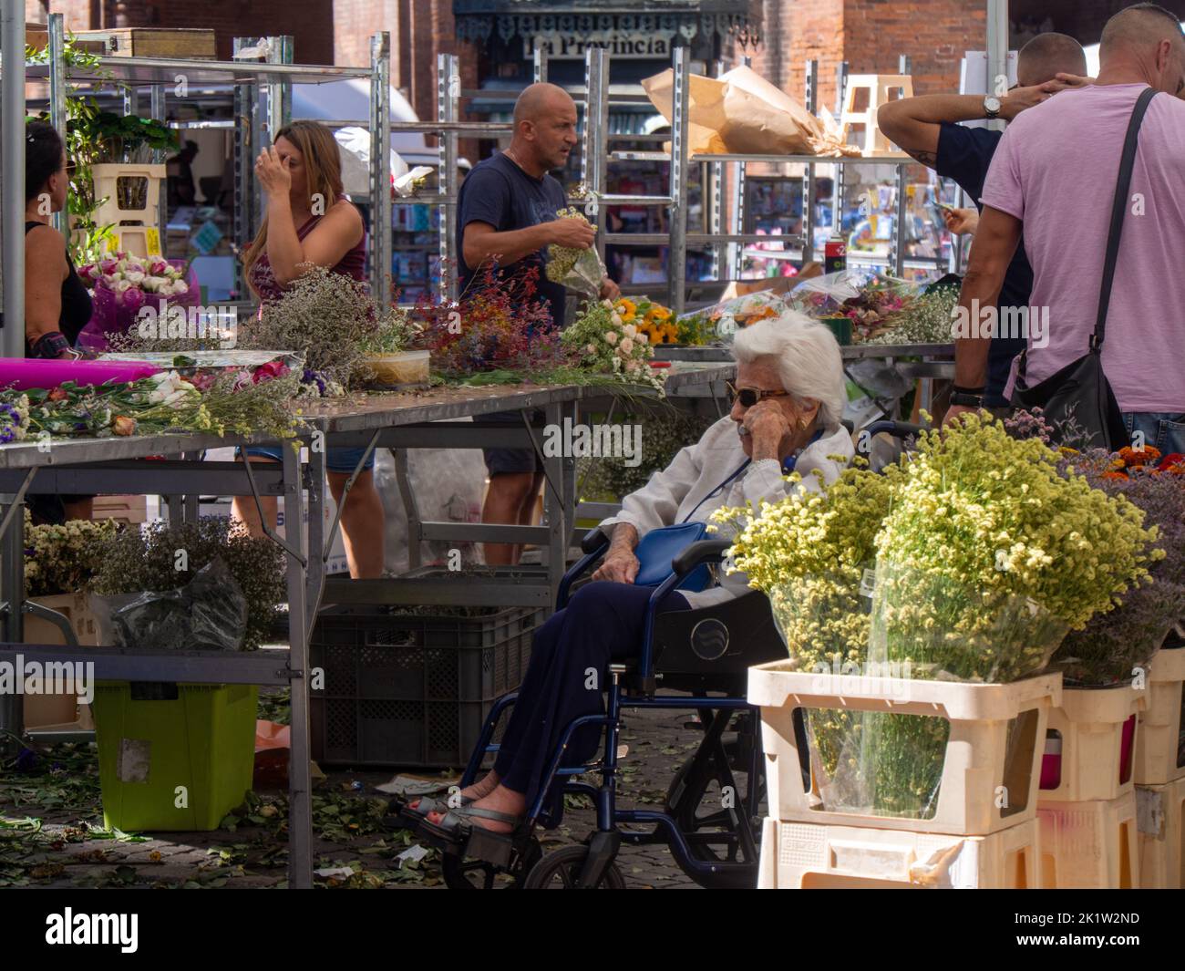 Several people gathered at an open flower market in Cremona Stock Photo