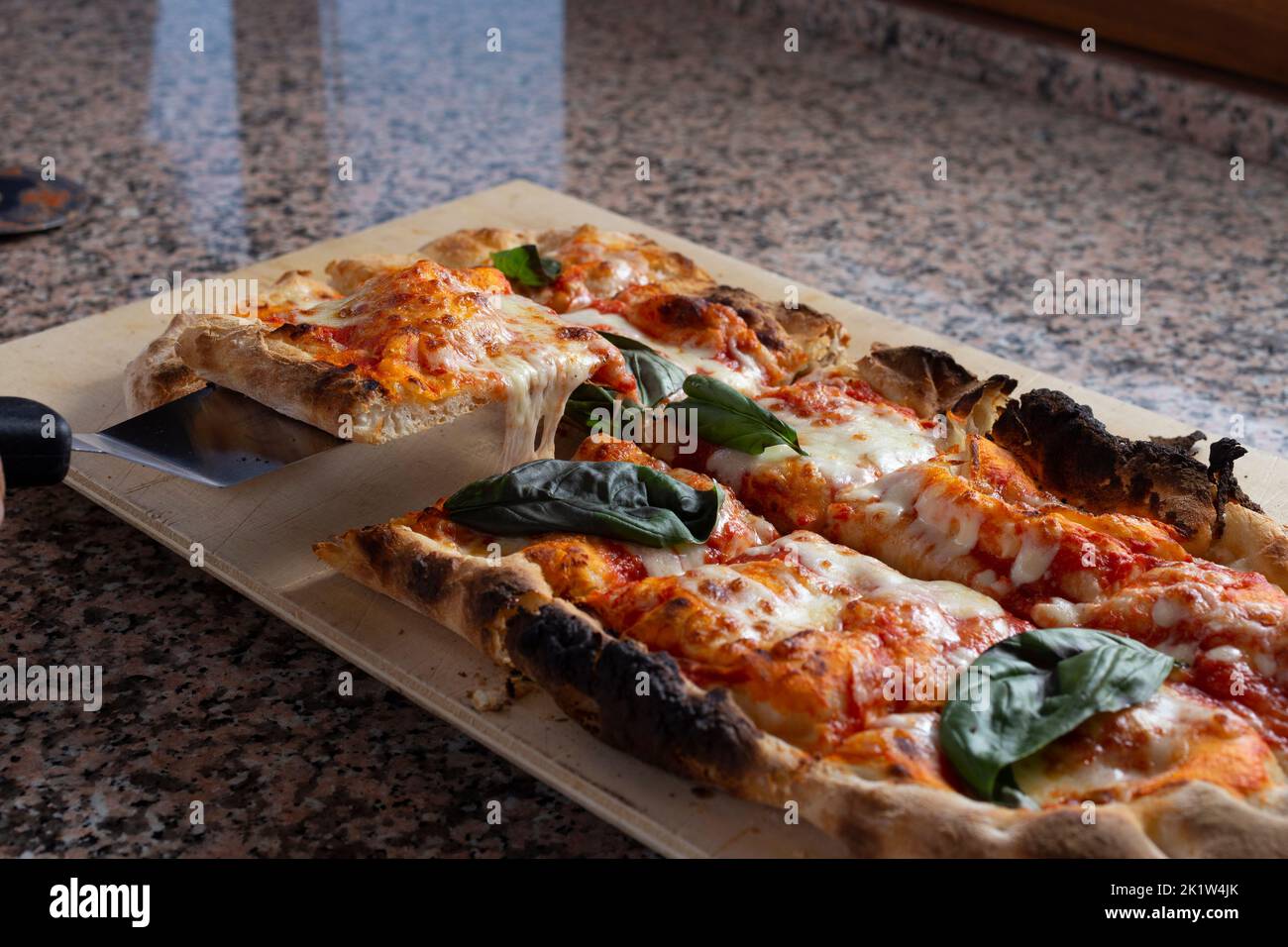 Square pizza on a marble place Stock Photo