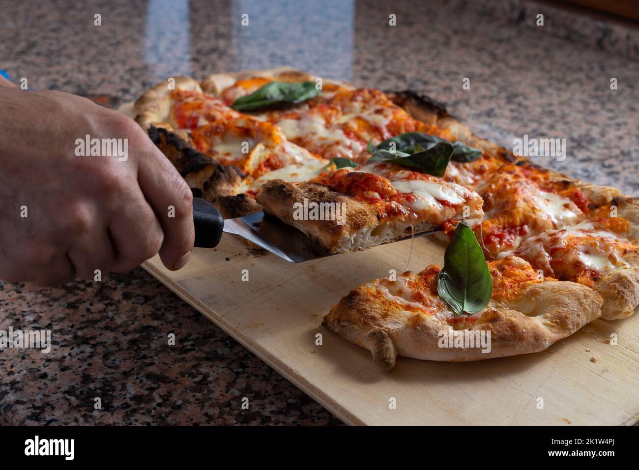 Square pizza on a marble place Stock Photo