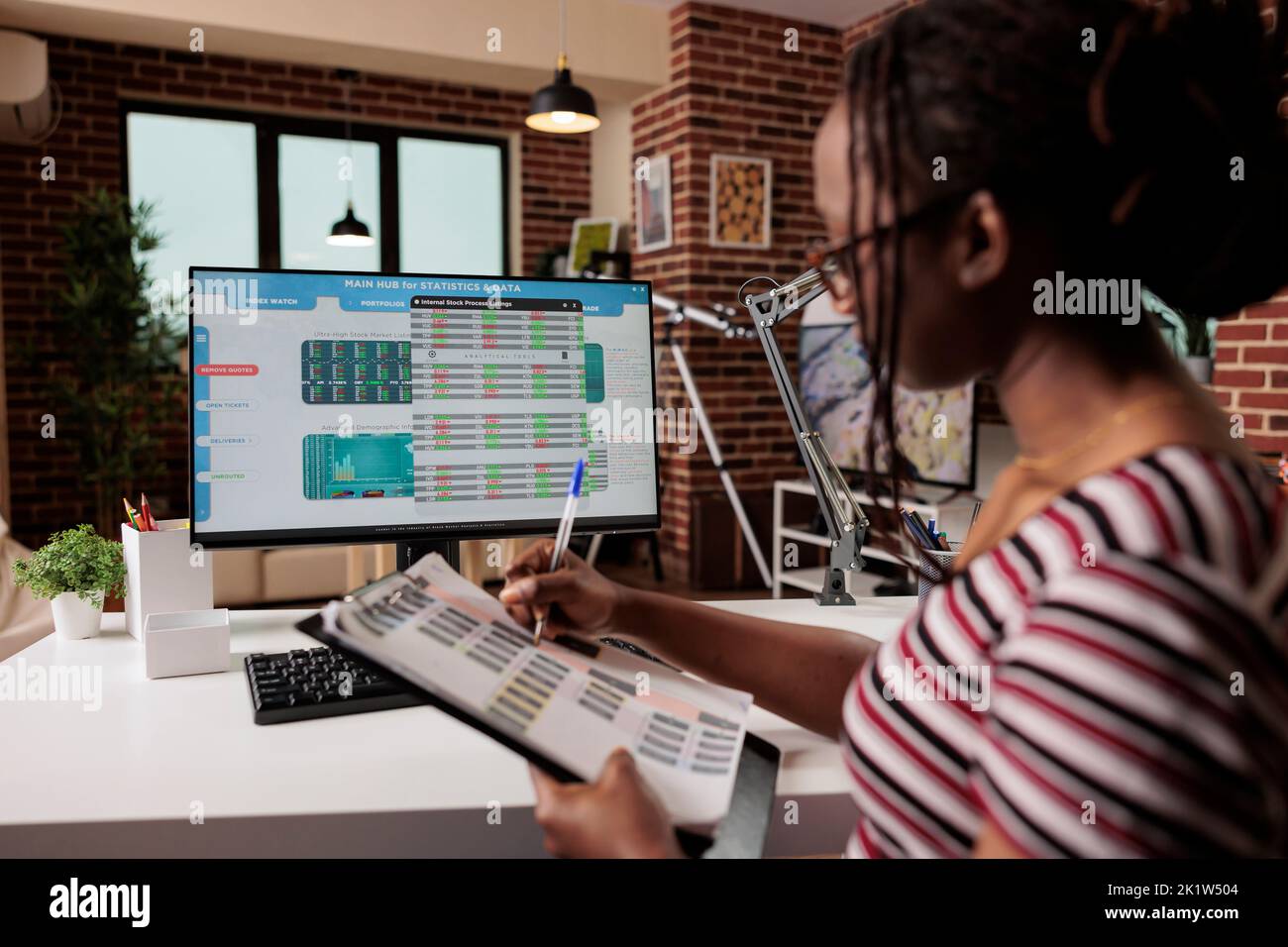 Woman analyzing statistics on computer screen, working with internet of things, using online application for work. Remote worker monitoring data, web 3 0, iot technology concept Stock Photo