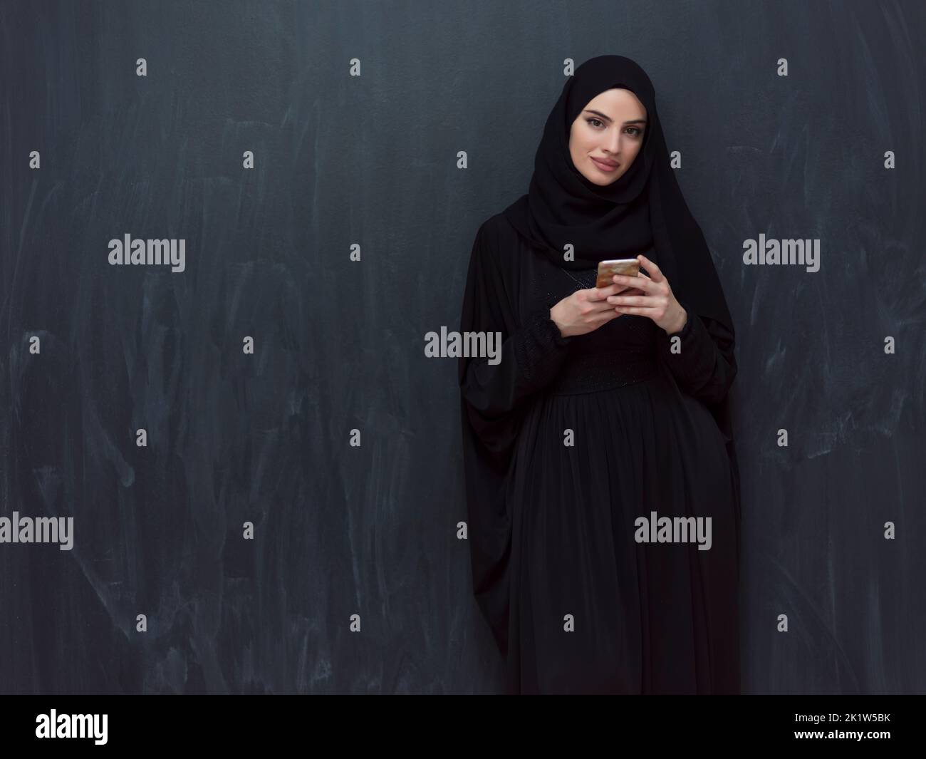 Young modern muslim business woman using smartphone wearing hijab ...